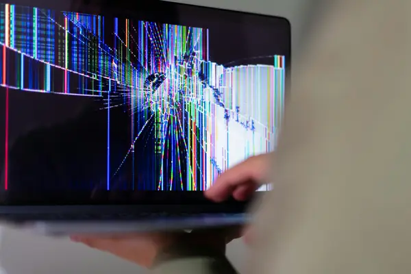 A stressed business owner working on a laptop with DIY website tools open